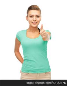 clothing design and happy people concept - smiling girl in blank blue t-shirt showing thumbs up gesture