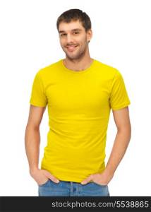 clothing design and hapy people concept - handsome man in blank yellow shirt