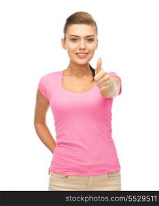 clothing design, health and breast cancer awareness concept - smiling girl in blank pink t-shirt showing thumbs up gesture