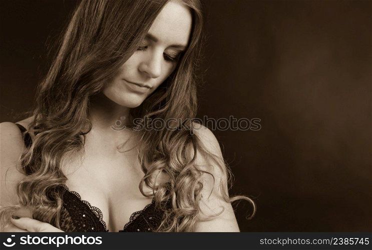 Clothing, fashion people concept. Sensual woman with sexy lingerie. Beautiful young lady wearing black corset. Girl has long hair.. Sensual woman with sexy lingerie.