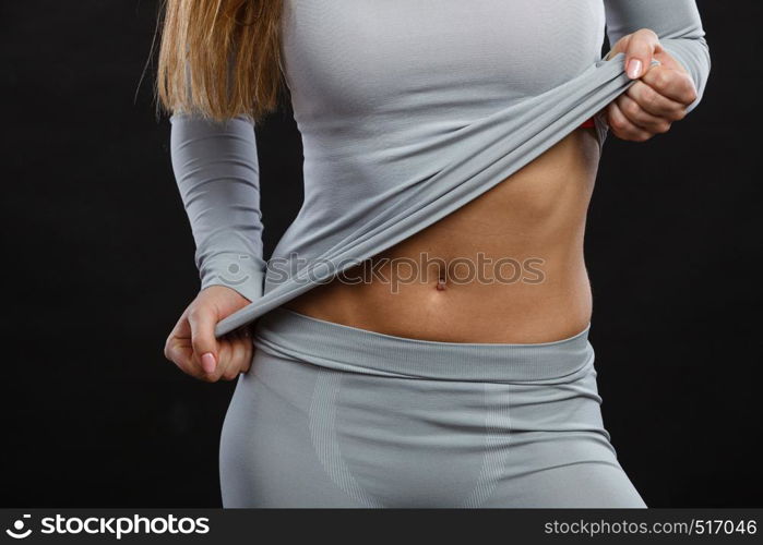 Clothing fashion sport concept. Part body picture with thermoactive underwear. Attractive fit woman promoting sporty clothes.. Part body picture with underwear.