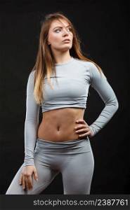Clothing fashion sport concept. Sporty woman wearing thermoactive underwear. Attractive sporty lady promoting clothes and showing her slim abdomen.. Sporty woman wearing thermoactive underwear.