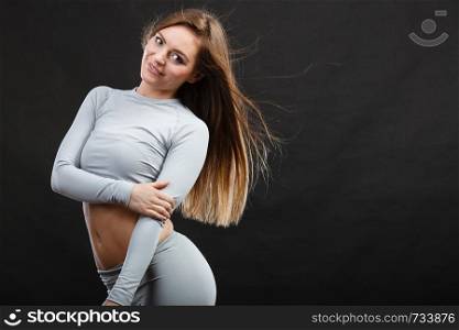 Clothing fashion sport concept. Sporty woman wearing thermoactive underwear. Attractive sporty lady promoting clothes and showing her slim abdomen.. Sporty woman wearing thermoactive underwear.