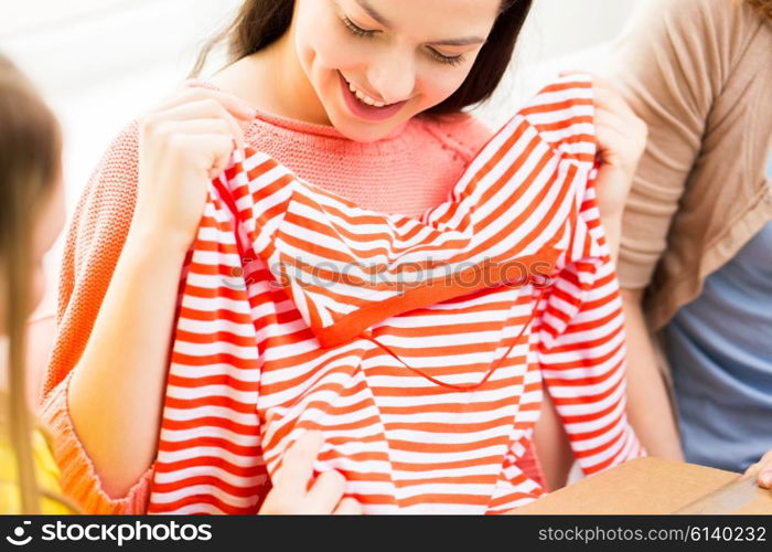 clothing, fashion, style and people concept - close up of happy young women or teenage girls with t-shirt