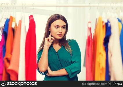 clothing, fashion, style and people concept - woman choosing clothes at home wardrobe. woman choosing clothes at home wardrobe