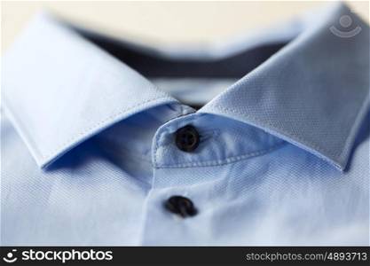 clothing, formal wear, fashion and objects concept - close up of blue shirt collar