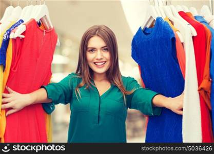 clothing, sale, fashion, style and people concept - happy woman choosing clothes at shopping center or mall. happy woman choosing clothes at home wardrobe