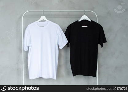 Clothing sale, place for logo, advertising, collaboration, T-shirt, print, place for text, close-up, hanger. Black and white T-shirt hanging on a hanger, layout