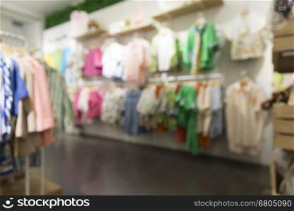 clothing selling in department store for use as shopping concept, blur background with bokeh light