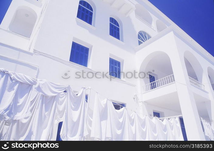 Cloths drying on a clothesline in front of a building