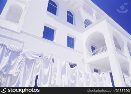 Cloths drying on a clothesline in front of a building