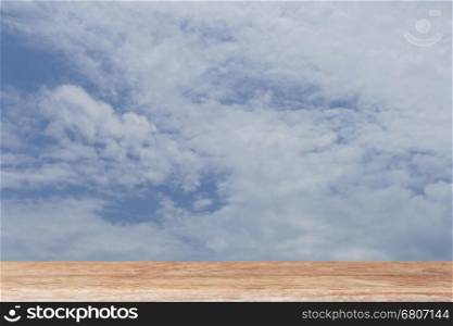 cloud and blue sky in daylight with wood table for montage or display your product