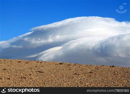 Cloud and blue sky in stone desert, Syria