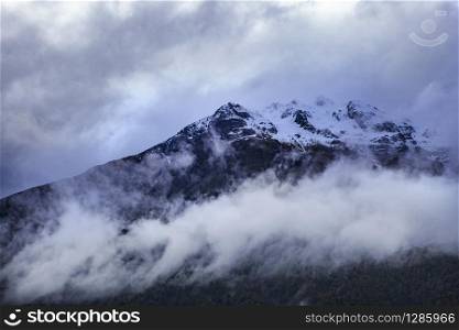 cloud and ice on peak of rock mountain in arthur&rsquo;s pass national park new zealand