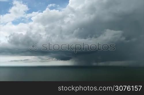 Cloud and rainstorm over the Pacific Ocean in Panama. Bad weather with cloudy sky, thunderstorm, pouring rain, thunder. Sea water, wind, tropical storm with thunderbolt. Tornado, hurricane, cyclone