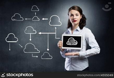 Cloud computing and connection concept. Young beautiful woman using tablet as symbol of modern technology