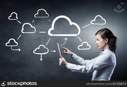Cloud computing and connection concept. Young beautiful woman using tablet as symbol of modern technology