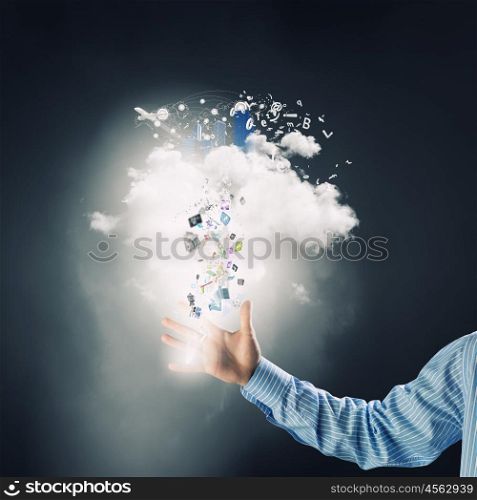 Cloud computing and technology. Hand of businessman and white cloud with flying icons