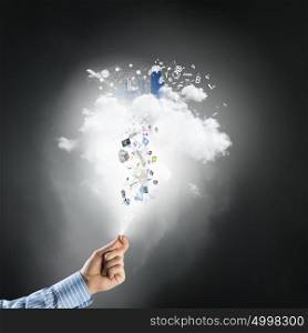 Cloud computing and technology. Hand of businessman and white cloud with flying icons