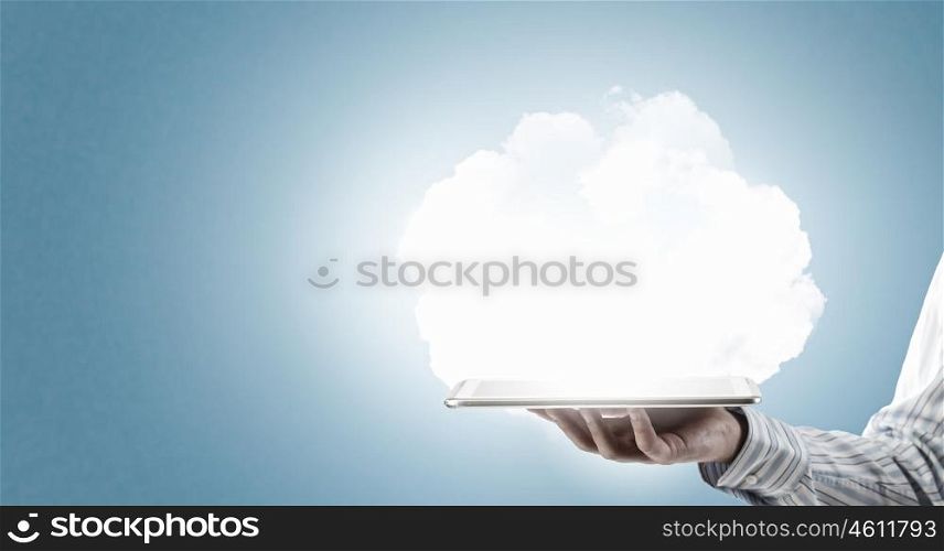 Cloud computing concept. Tablet pc in hands of businessman and cloud concept