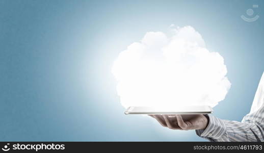 Cloud computing concept. Tablet pc in hands of businessman and cloud concept