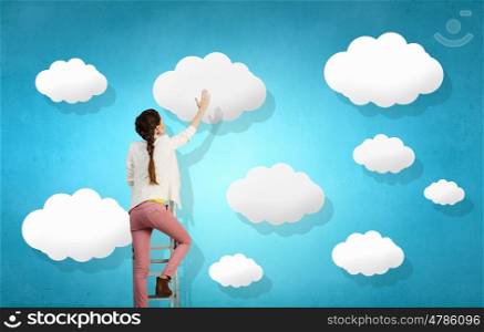 Cloud computing connection. Rear view of woman touching white cloud concept on blue background