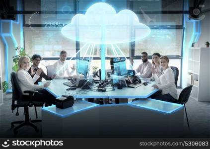 cloud computing, future technology and people concept - business team with computers waving hands at office. happy business team with cloud computing hologram