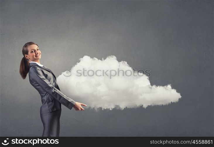 Cloud computing. Smiling businesswoman carrying big cloud in hands