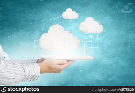 Cloud computing. Tablet pc in hands of businessman and cloud concept