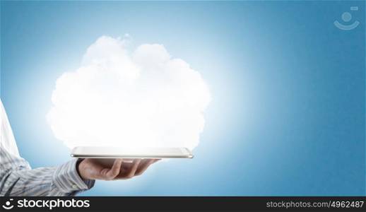 Cloud computing. Tablet pc in hands of businessman and cloud concept