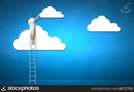 Cloud concept. Back view of businesswoman standing on ladder and reaching to cloud