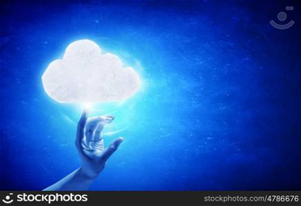 Cloud concept. Person hand touching glowing cloud on blue background
