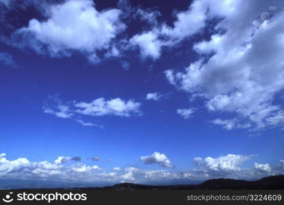 Cloud Filled Blue Sky Over Mountains