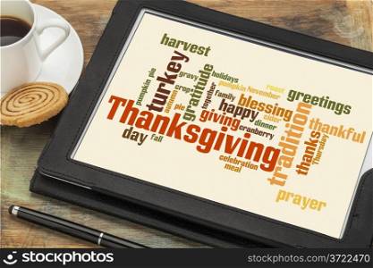 cloud of words or tags related to celebration of Thanksgiving Day on a digital tablet with a cup of coffee