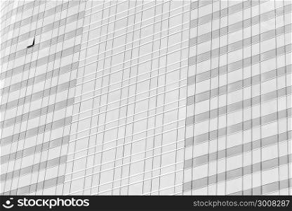 Cloud reflection in high glass offices. Blue reflection of the sky. Windows of a building. Business background in monochrome.