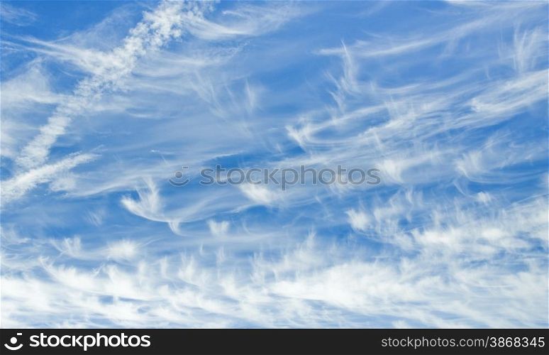 cloudescape of cirrus clouds and aircraft vapor trails