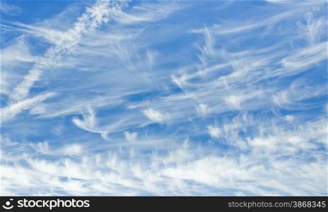 cloudescape of cirrus clouds and aircraft vapor trails