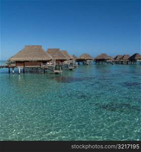 Cloudless Sky with Huts over Ocean at Moorea in Tahiti