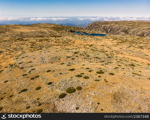 Clouds above mountain top of Serra da Estrela or Star Mountain Range. Torre peak. The highest place in Continental Portugal. Aerial view. Aerial view. Clouds above mountain. Torre peak in Portugal