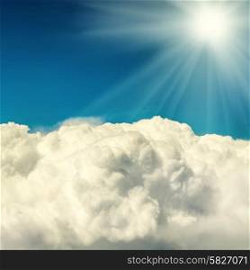 Clouds and blue sky. Natural background with shining sun