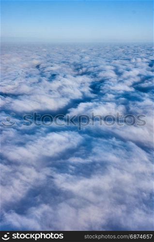 clouds and blue sky seen from airplane