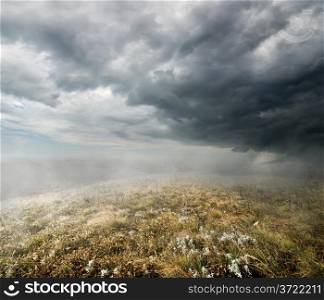 Clouds and fog over the autumn field