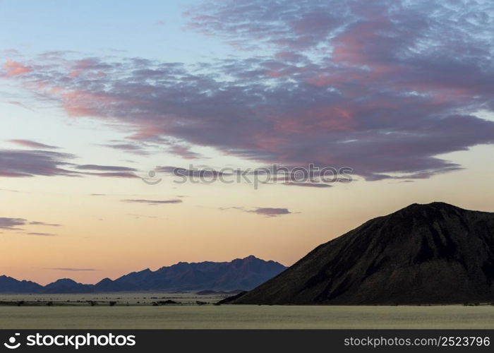 Clouds colored red after sunset Namib desert Namibia