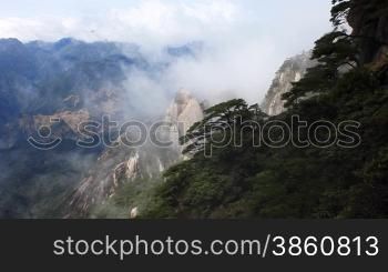 clouds crossing over mountain in China.