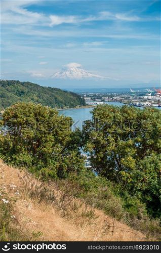 Clouds hover near Mount Rainier with the Port of Tacoma below.