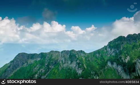 Clouds in blue sky and Kaukaz mountains time lapse