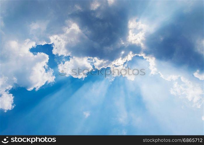 clouds in blue sky with sun rays