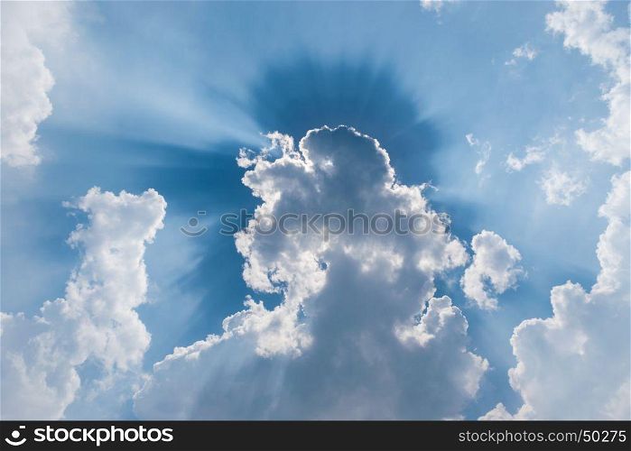 clouds in blue sky with sunrays