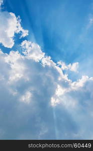 clouds in blue sky with sunrays