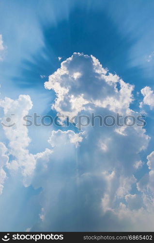 clouds in blue sky with sunrays